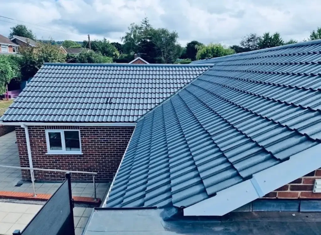 New grey tiled roof replacement on a brick house