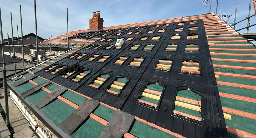 Solar panel mounting rails being fitted to a roof