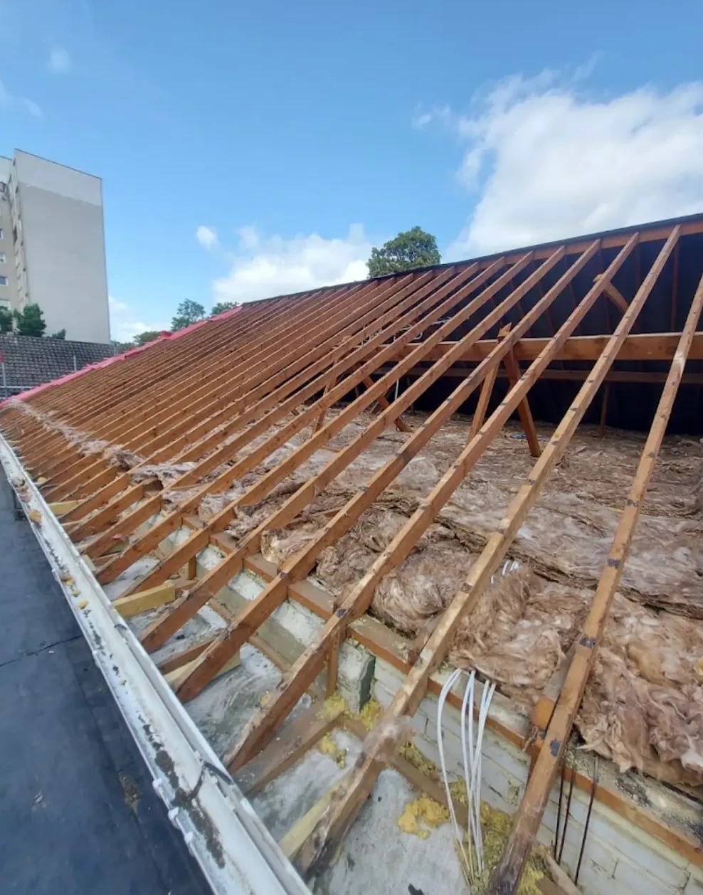 Roof stripped back to rafters and insulation before replacement