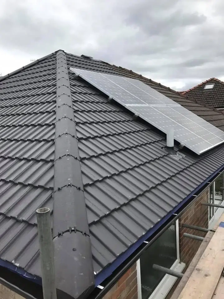 Solar panels installed on a grey tiled roof