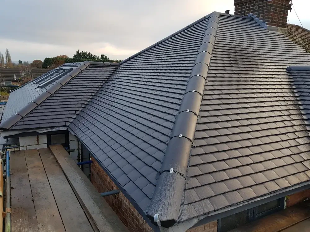 Completed grey tiled roof replacement with new ridge line