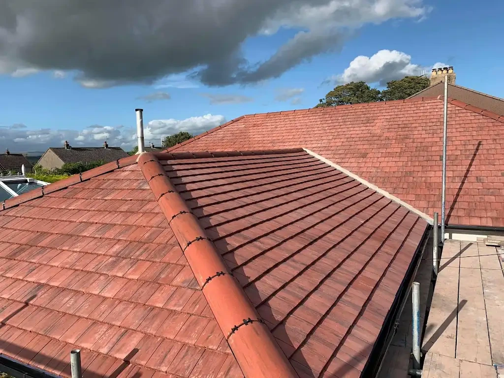 Finished terracotta tile roof replacement with bedded ridge detailing